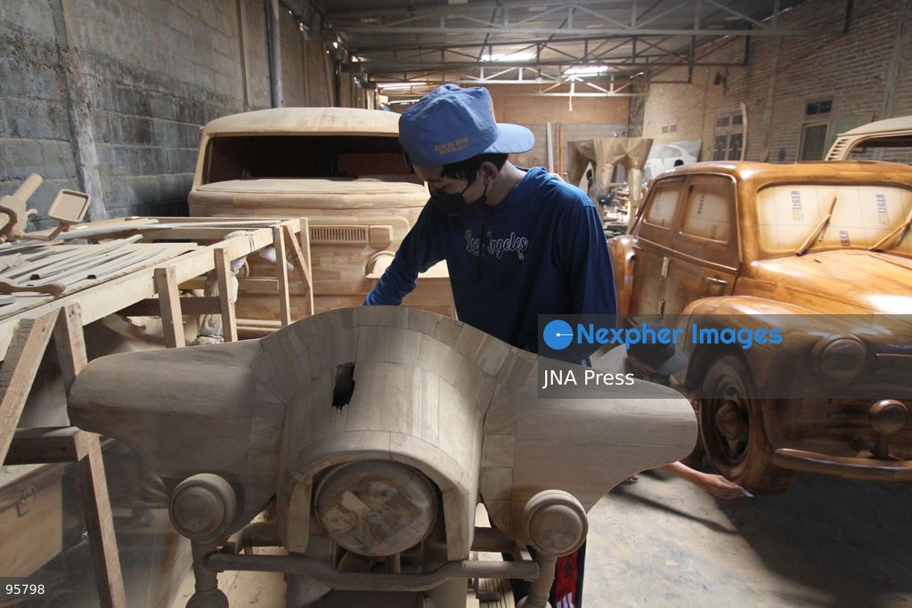 BOYOLALI, INDONESIA — SEPTEMBER 22, 2026: A worker applies a layer of varnish to a 1:1 scale wooden car and Harley-Davidson replica made from teak wood at Tetap Jaya Art Industrial House in Kemiri Village, Mojosongo District, Boyolali Regency, Central Java. The 1:1 scale vehicles take approximately one and a half months to complete, while smaller models take about two weeks. The products are ordered by buyers from several European countries at prices reaching tens of millions of rupiah. Mercedes-Benz, Renault, Ford, and Volkswagen cars, as well as Harley-Davidson and Vespa motorcycles, are among the customers' favorite models in European countries. Photo by Agung Mardika / JNA Press. (Photo by JNA EDITOR/JNA Press via Nexpher Images)