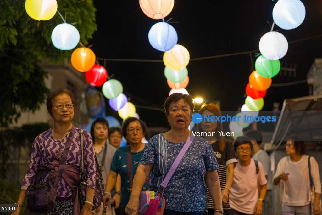 People walking under lanterns hanging in the air. the Mid autumn festival lights at Shek O on September 23, 2026 in Hong Kong. (Photo by Vernon Yuen/Nexpher Images)