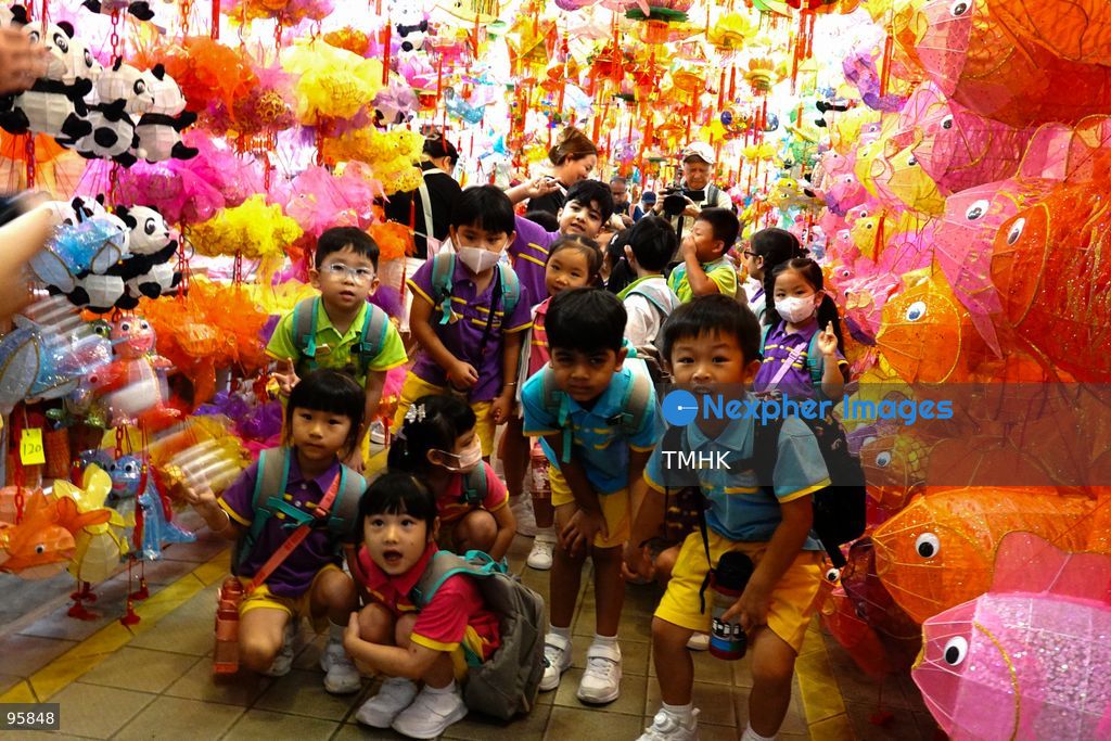 Children look up in delight at a ceiling filled with traditional handmade paper lanterns and colourful plastic lanterns during a visit to an old shop on September 22, 2026 in Hong Kong, discovering classic festive customs ahead of the Mid-Autumn Festival. (Photo by Zulu Lo/TMHK via Nexpher Images)