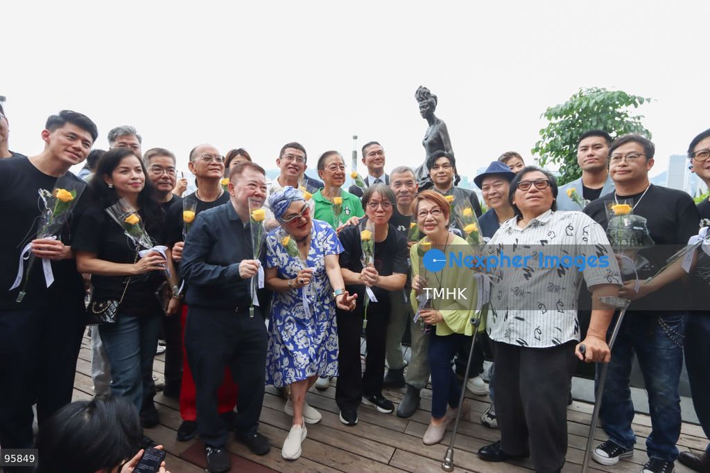 Members of the fan club "Mui Nation", joined by veteran radio host Candy Chea Shuk-mui, former broadcasting executive Cheung Man-sun, filmmaker Manfred Wong, and veteran actress Susan Shaw Yin-yin, pose for a photograph in front of the newly restored bronze statue of the late pop diva Anita Mui at the Avenue of Stars on September 22, 2026 in Hong Kong. The fan club funded the HK$100,000 restoration project to repair severe sea-breeze corrosion on the iconic waterfront landmark. (Photo by Gordon Choi/TMHK via Nexpher Images)