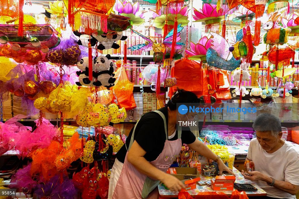 Surrounded by a dense display of traditional paper and classic plastic lanterns, the shopkeeper couple attend to daily business routines and serve neighbourhood customers on September 22, 2026 in Hong Kong, ahead of the Mid-Autumn Festival. (Photo by Zulu Lo/TMHK via Nexpher Images)