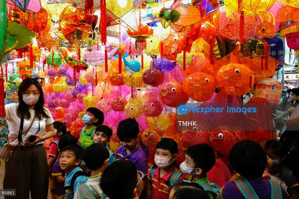Children look up in delight at a ceiling filled with traditional handmade paper lanterns and colourful plastic lanterns during a visit to an old shop on September 22, 2026 in Hong Kong, discovering classic festive customs ahead of the Mid-Autumn Festival. (Photo by Zulu Lo/TMHK via Nexpher Images)