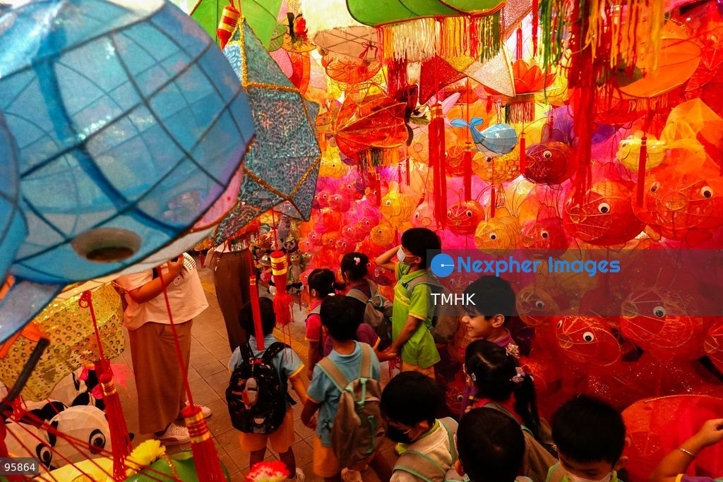 Children look up in delight at a ceiling filled with traditional handmade paper lanterns and colourful plastic lanterns during a visit to an old shop on September 22, 2026 in Hong Kong, discovering classic festive customs ahead of the Mid-Autumn Festival. (Photo by Zulu Lo/TMHK via Nexpher Images)