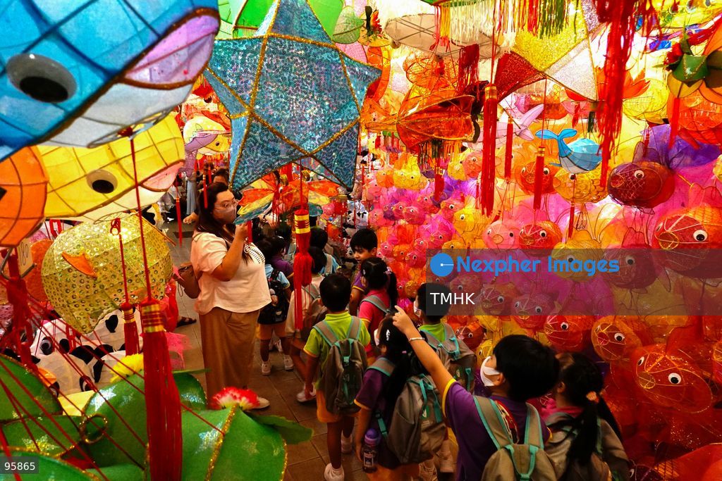 Children look up in delight at a ceiling filled with traditional handmade paper lanterns and colourful plastic lanterns during a visit to an old shop on September 22, 2026 in Hong Kong, discovering classic festive customs ahead of the Mid-Autumn Festival. (Photo by Zulu Lo/TMHK via Nexpher Images)