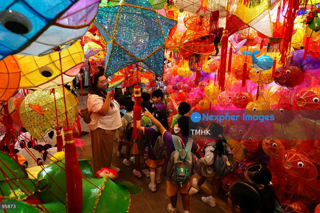 Children look up in delight at a ceiling filled with traditional handmade paper lanterns and colourful plastic lanterns during a visit to an old shop on September 22, 2026 in Hong Kong, discovering classic festive customs ahead of the Mid-Autumn Festival. (Photo by Zulu Lo/TMHK via Nexpher Images)