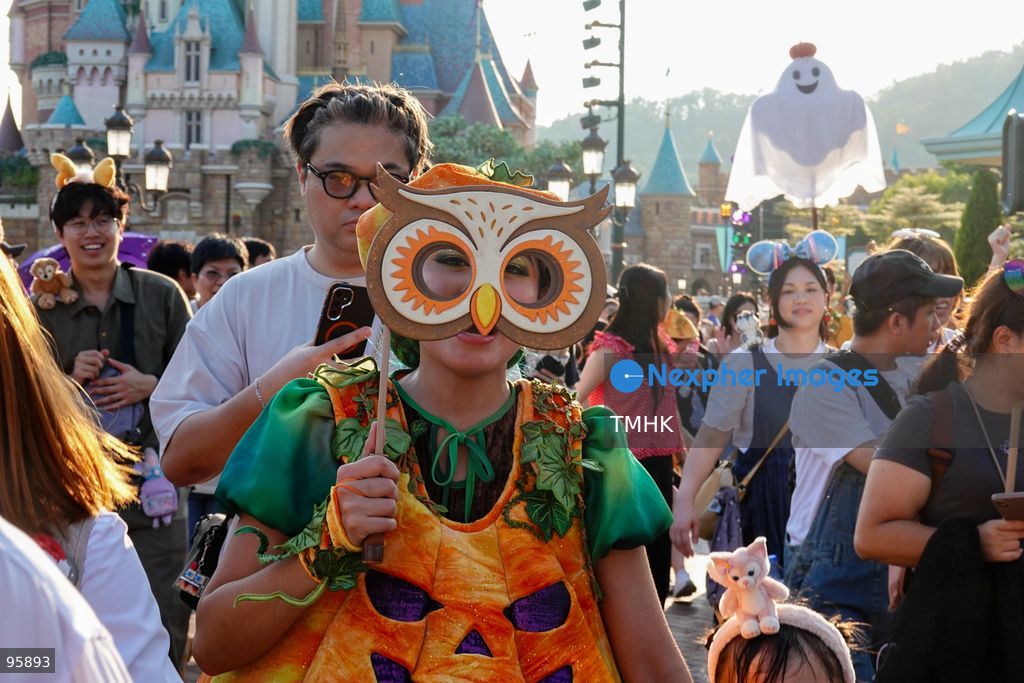 Visitors dressed in creative pumpkin-themed costumes take photographs and take part in seasonal celebrations in front of the Castle of Magical Dreams during "Disney Halloween Time" at Hong Kong Disneyland on September 20, 2026 in Hong Kong. (Photo by Zulu Lo/TMHK via Nexpher Images)