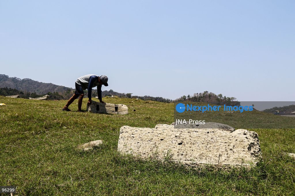 KULON PROGO, YOGYAKARTA, INDONESIA, SEPTEMBER 24, 2026: An old cemetery complex emerges as water levels recede at the Sermo Reservoir in Kulon Progo, Yogyakarta. The cemetery was among areas affected during construction of the reservoir between 1994 and 1996. Reservoir authorities said the lower water level has not disrupted operations or community water supplies, with the reservoir holding approximately 15 million cubic meters of water. Photo by Ilham Nur Arifin / JNA Press. (Photo by Ilham Nur Arifin/JNA Press via Nexpher Images)