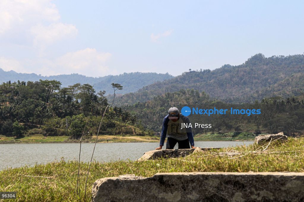 KULON PROGO, YOGYAKARTA, INDONESIA, SEPTEMBER 24, 2026: An old cemetery complex emerges as water levels recede at the Sermo Reservoir in Kulon Progo, Yogyakarta. The cemetery was among areas affected during construction of the reservoir between 1994 and 1996. Reservoir authorities said the lower water level has not disrupted operations or community water supplies, with the reservoir holding approximately 15 million cubic meters of water. Photo by Ilham Nur Arifin / JNA Press. (Photo by Ilham Nur Arifin/JNA Press via Nexpher Images)
