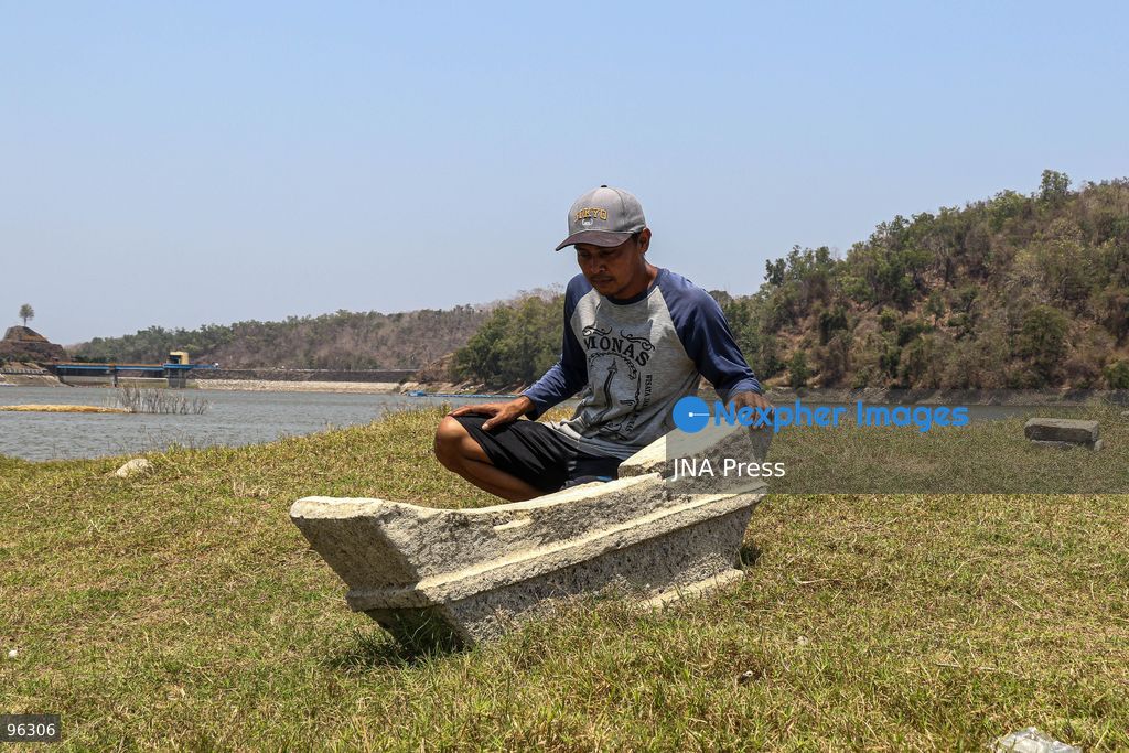 KULON PROGO, YOGYAKARTA, INDONESIA, SEPTEMBER 24, 2026: An old cemetery complex emerges as water levels recede at the Sermo Reservoir in Kulon Progo, Yogyakarta. The cemetery was among areas affected during construction of the reservoir between 1994 and 1996. Reservoir authorities said the lower water level has not disrupted operations or community water supplies, with the reservoir holding approximately 15 million cubic meters of water. Photo by Ilham Nur Arifin / JNA Press. (Photo by Ilham Nur Arifin/JNA Press via Nexpher Images)