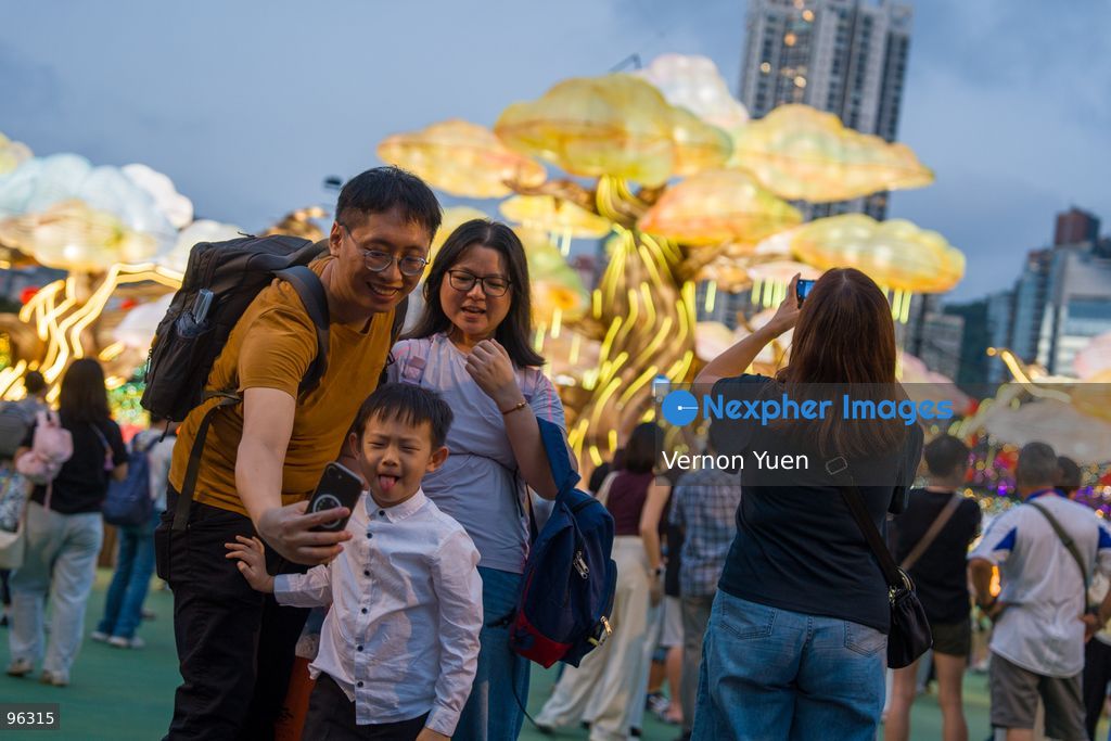 People taking selfie with the mid autumn festival lights at Victoria Park on September 24, 2026 in Hong Kong. (Photo by Vernon Yuen/Nexpher Images)
