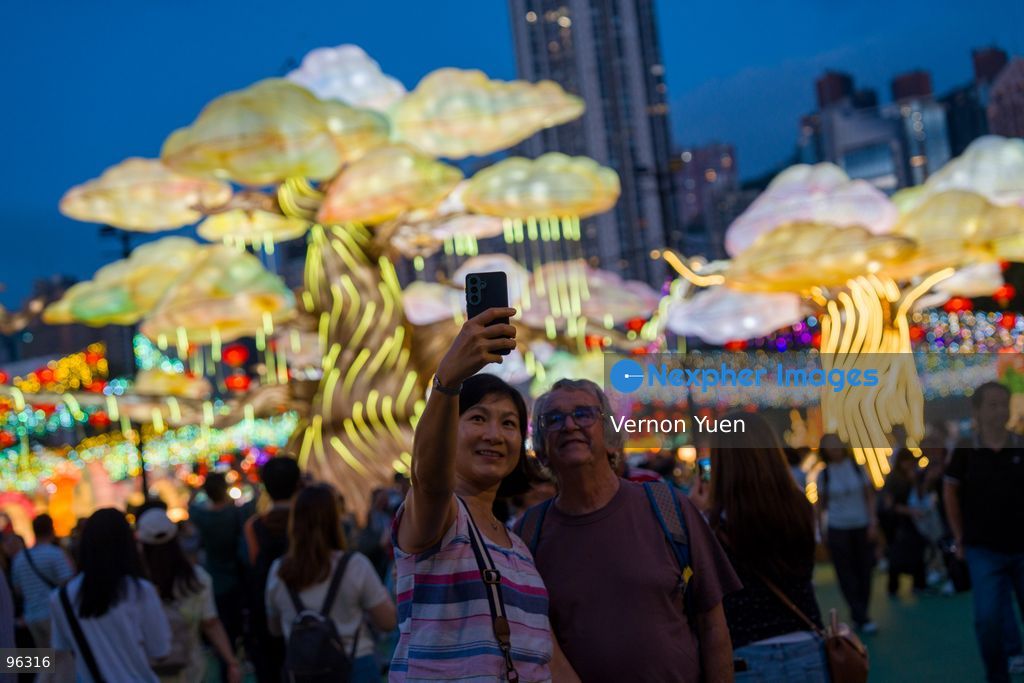 People taking selfie with the mid autumn festival lights at Victoria Park on September 24, 2026 in Hong Kong. (Photo by Vernon Yuen/Nexpher Images)
