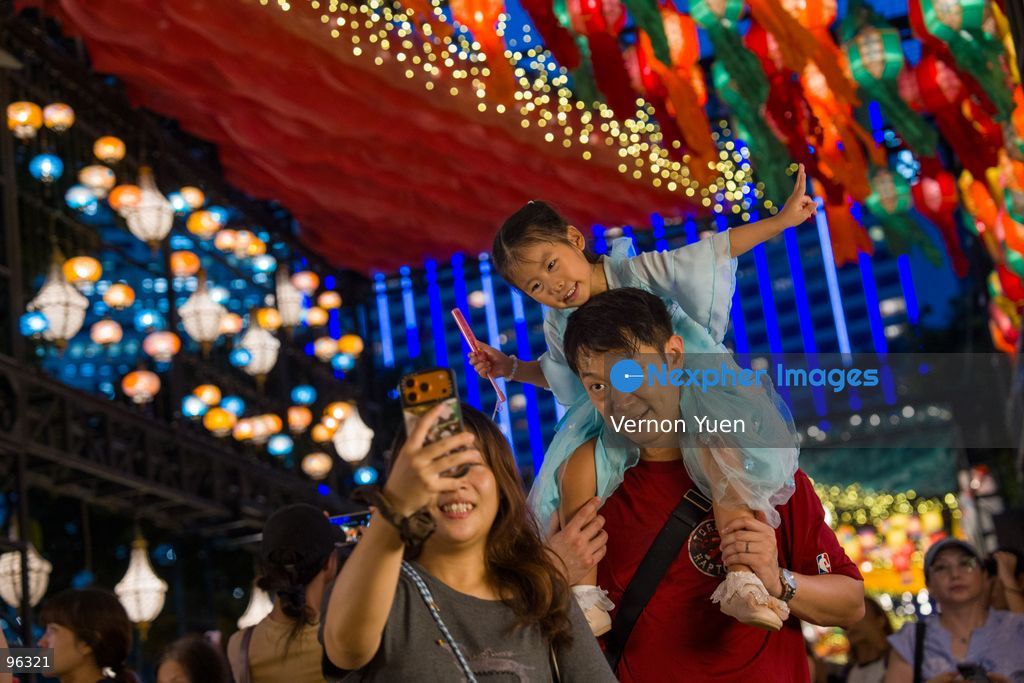 People taking selfie with the mid autumn festival lights at Victoria Park on September 24, 2026 in Hong Kong. (Photo by Vernon Yuen/Nexpher Images)