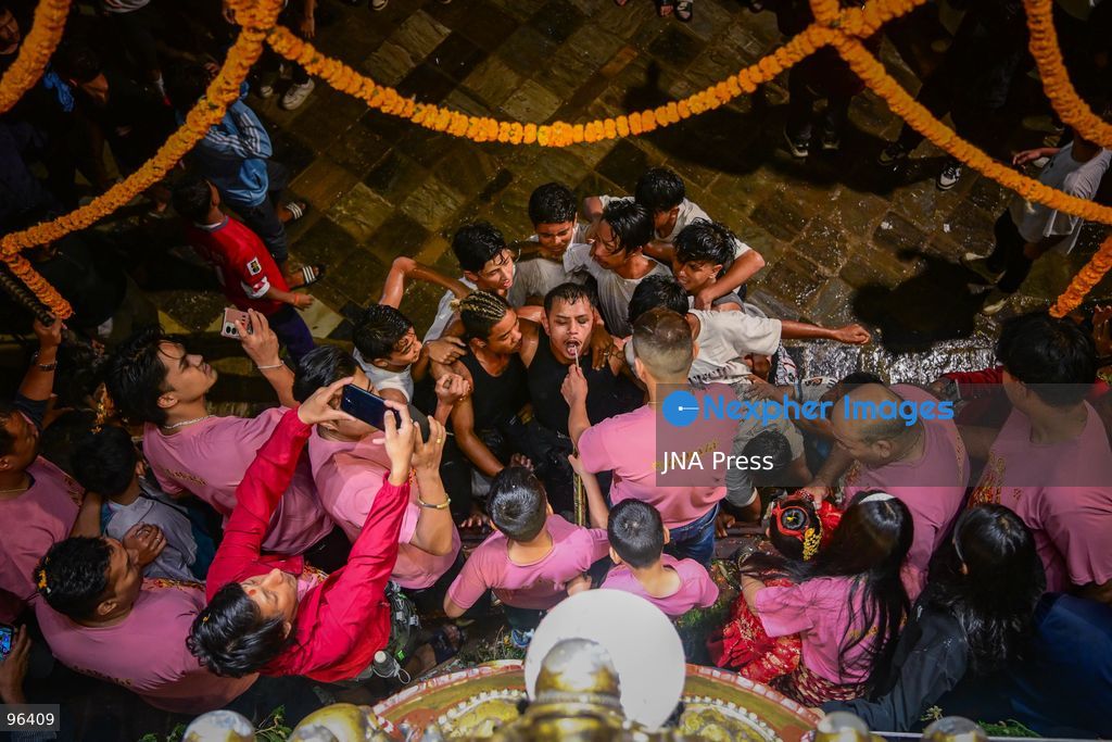KATHMANDU, NEPAL, SEPTEMBER 24, 2026: Revelers gather around the Swet Bhairab mask to receive rice beer flowing through a brass spout from the deity’s mouth during the second day of the Indra Jatra festival at Kathmandu Durbar Square. The drink is traditionally regarded as a blessing by devotees. Swet Bhairab, a representation of the Hindu deity Bhairava, is displayed publicly during the annual festival and remains covered for much of the rest of the year. Indra Jatra is an eight-day religious and cultural festival featuring processions, masked dances and traditional rituals in Kathmandu. Photo by Safal Prakash Shrestha / JNA Press. (Photo by Safal Prakash Shrestha/JNA Press via Nexpher Images)