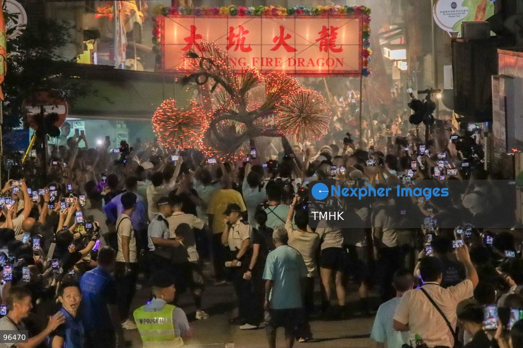 A general view shows the 67-metre-long fire dragon, bristling with thousands of burning incense sticks, parading through Wun Sha Street and the narrow alleys of Tai Hang amidst dense crowds on September 24, 2026 in Hong Kong. The centenary tradition, inscribed on the National List of Intangible Cultural Heritage, marks the festive celebration of the Mid-Autumn Festival. (Photo by Gordon Choi/TMHK via Nexpher Images)