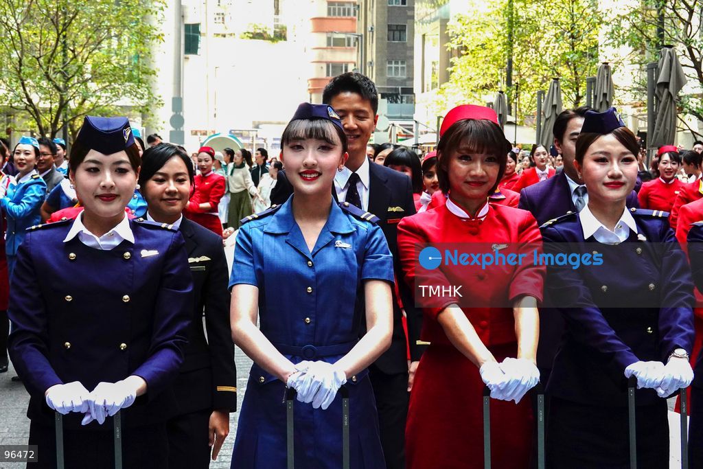 A general view shows cabin crew and ground staff wearing vintage and current uniforms performing alongside professional dancers during Cathay Pacific's 80th anniversary dance performance at Taikoo Place in Quarry Bay on September 24, 2026 in Hong Kong. Choreographed by the Hong Kong Dance Company, the flash mob-style showcase celebrated the airline's eight decades of journey alongside the city. (Photo by Zulu Lo/TMHK via Nexpher Images)