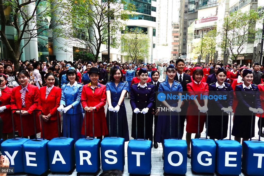 A general view shows cabin crew and ground staff wearing vintage and current uniforms performing alongside professional dancers during Cathay Pacific's 80th anniversary dance performance at Taikoo Place in Quarry Bay on September 24, 2026 in Hong Kong. Choreographed by the Hong Kong Dance Company, the flash mob-style showcase celebrated the airline's eight decades of journey alongside the city. (Photo by Zulu Lo/TMHK via Nexpher Images)