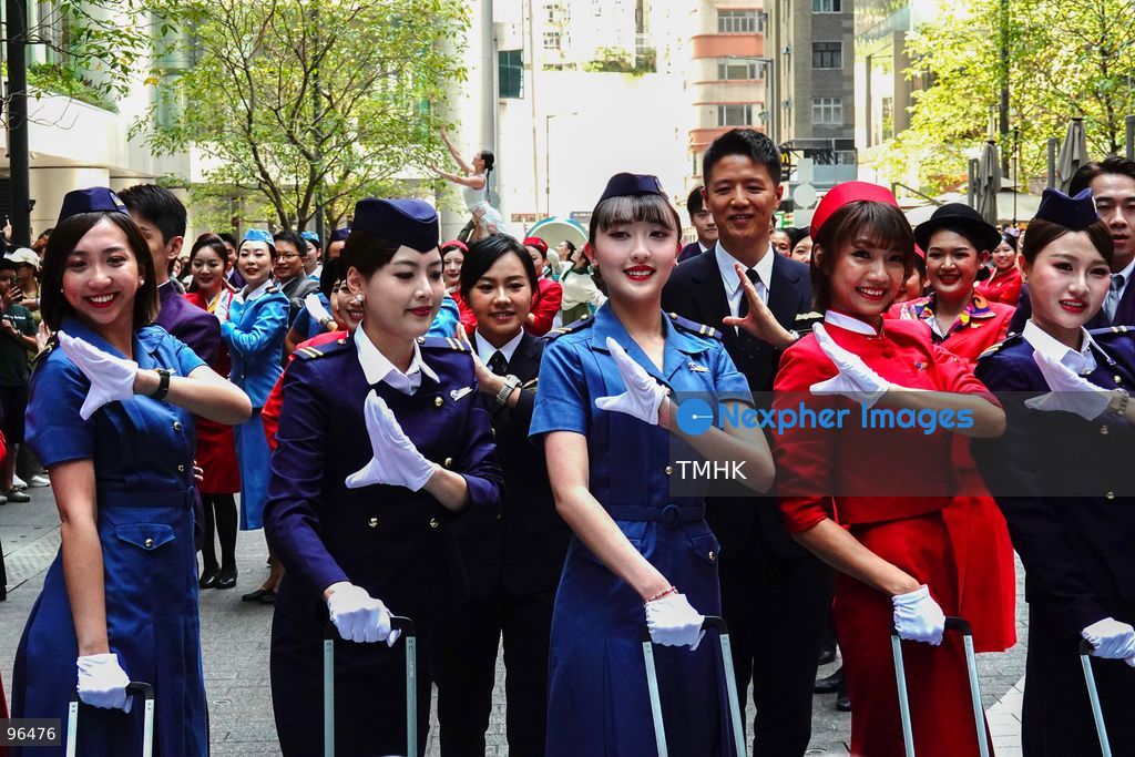 A general view shows cabin crew and ground staff wearing vintage and current uniforms performing alongside professional dancers during Cathay Pacific's 80th anniversary dance performance at Taikoo Place in Quarry Bay on September 24, 2026 in Hong Kong. Choreographed by the Hong Kong Dance Company, the flash mob-style showcase celebrated the airline's eight decades of journey alongside the city. (Photo by Zulu Lo/TMHK via Nexpher Images)