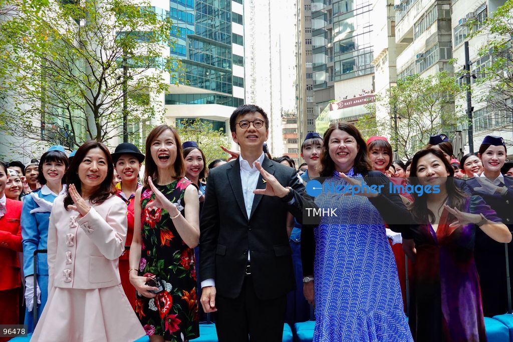 Cathay Pacific Chief Executive Officer Ronald Lam Siu-por, Chief Customer and Commercial Officer Lavinia Lau Hoi-sze, and Chief Financial Officer Rebecca Sharpe pose for a group photograph with participating cabin crew, frontline staff, and dancers following an 80th anniversary dance performance at Taikoo Place on September 24, 2026 in Hong Kong. (Photo by Zulu Lo/TMHK via Nexpher Images)