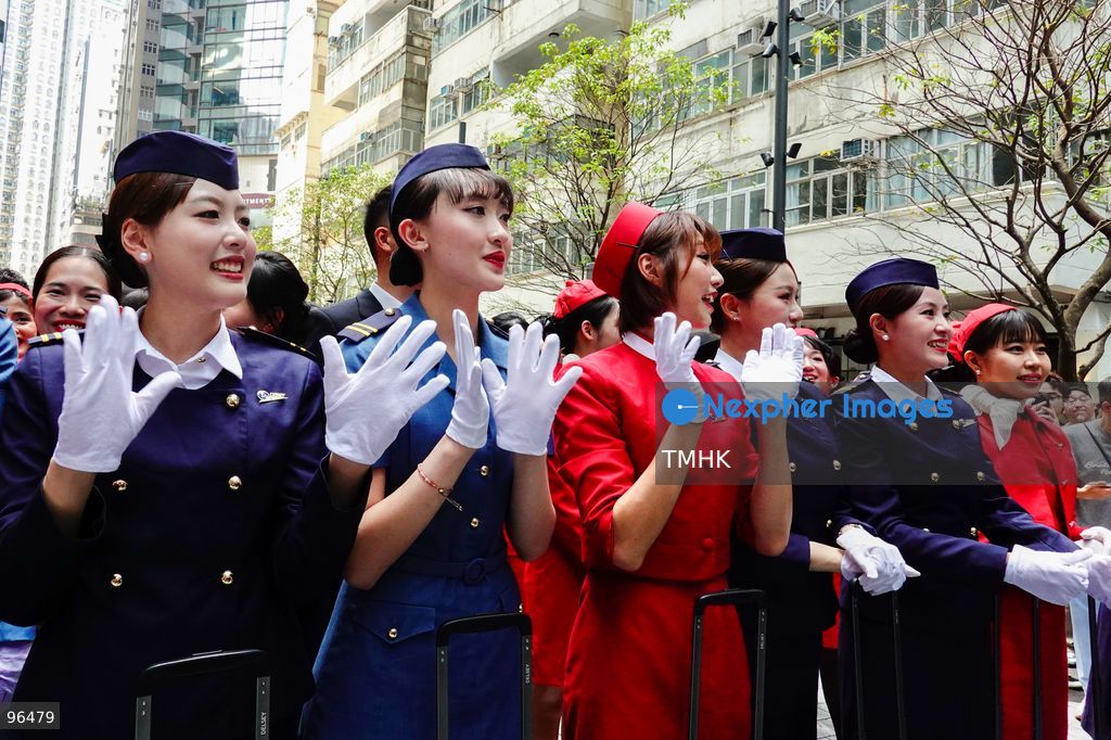 A general view shows cabin crew and ground staff wearing vintage and current uniforms performing alongside professional dancers during Cathay Pacific's 80th anniversary dance performance at Taikoo Place in Quarry Bay on September 24, 2026 in Hong Kong. Choreographed by the Hong Kong Dance Company, the flash mob-style showcase celebrated the airline's eight decades of journey alongside the city. (Photo by Zulu Lo/TMHK via Nexpher Images)