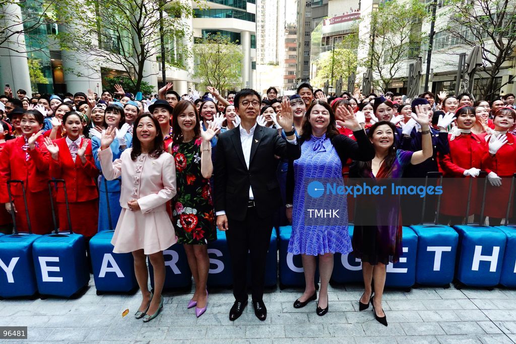Cathay Pacific Chief Executive Officer Ronald Lam Siu-por, Chief Customer and Commercial Officer Lavinia Lau Hoi-sze, and Chief Financial Officer Rebecca Sharpe pose for a group photograph with participating cabin crew, frontline staff, and dancers following an 80th anniversary dance performance at Taikoo Place on September 24, 2026 in Hong Kong. (Photo by Zulu Lo/TMHK via Nexpher Images)