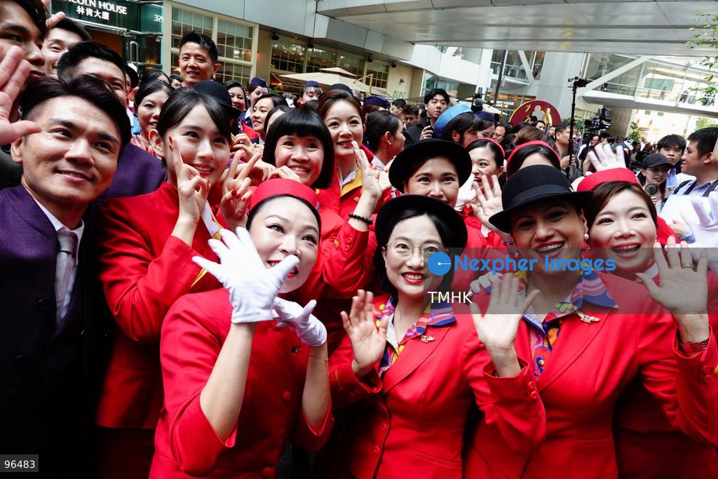 A general view shows cabin crew and ground staff wearing vintage and current uniforms performing alongside professional dancers during Cathay Pacific's 80th anniversary dance performance at Taikoo Place in Quarry Bay on September 24, 2026 in Hong Kong. Choreographed by the Hong Kong Dance Company, the flash mob-style showcase celebrated the airline's eight decades of journey alongside the city. (Photo by Zulu Lo/TMHK via Nexpher Images)