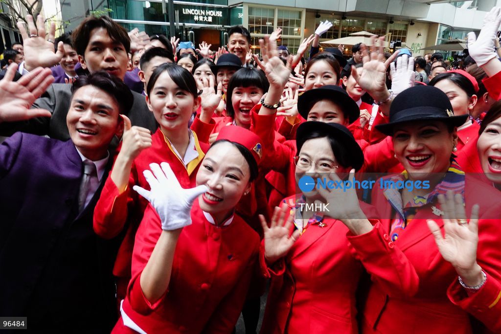 A general view shows cabin crew and ground staff wearing vintage and current uniforms performing alongside professional dancers during Cathay Pacific's 80th anniversary dance performance at Taikoo Place in Quarry Bay on September 24, 2026 in Hong Kong. Choreographed by the Hong Kong Dance Company, the flash mob-style showcase celebrated the airline's eight decades of journey alongside the city. (Photo by Zulu Lo/TMHK via Nexpher Images)