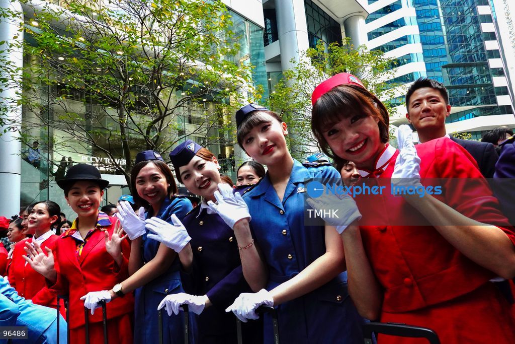 A general view shows cabin crew and ground staff wearing vintage and current uniforms performing alongside professional dancers during Cathay Pacific's 80th anniversary dance performance at Taikoo Place in Quarry Bay on September 24, 2026 in Hong Kong. Choreographed by the Hong Kong Dance Company, the flash mob-style showcase celebrated the airline's eight decades of journey alongside the city. (Photo by Zulu Lo/TMHK via Nexpher Images)