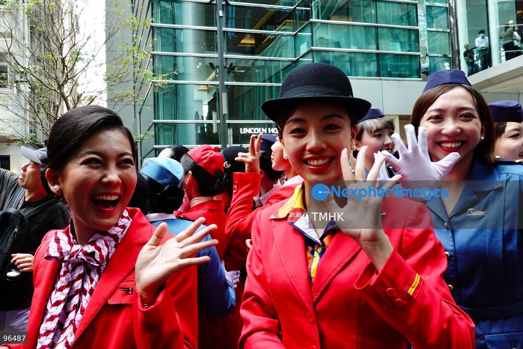 A general view shows cabin crew and ground staff wearing vintage and current uniforms performing alongside professional dancers during Cathay Pacific's 80th anniversary dance performance at Taikoo Place in Quarry Bay on September 24, 2026 in Hong Kong. Choreographed by the Hong Kong Dance Company, the flash mob-style showcase celebrated the airline's eight decades of journey alongside the city. (Photo by Zulu Lo/TMHK via Nexpher Images)