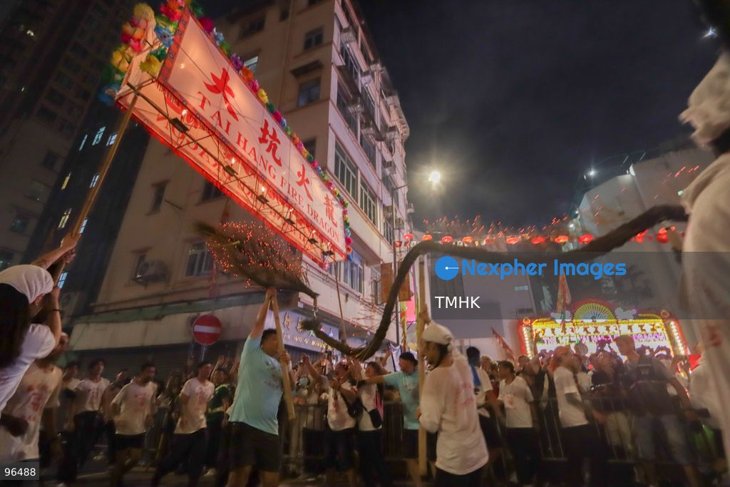 A general view shows the 67-metre-long fire dragon, bristling with thousands of burning incense sticks, parading through Wun Sha Street and the narrow alleys of Tai Hang amidst dense crowds on September 24, 2026 in Hong Kong. The centenary tradition, inscribed on the National List of Intangible Cultural Heritage, marks the festive celebration of the Mid-Autumn Festival. (Photo by Gordon Choi/TMHK via Nexpher Images)