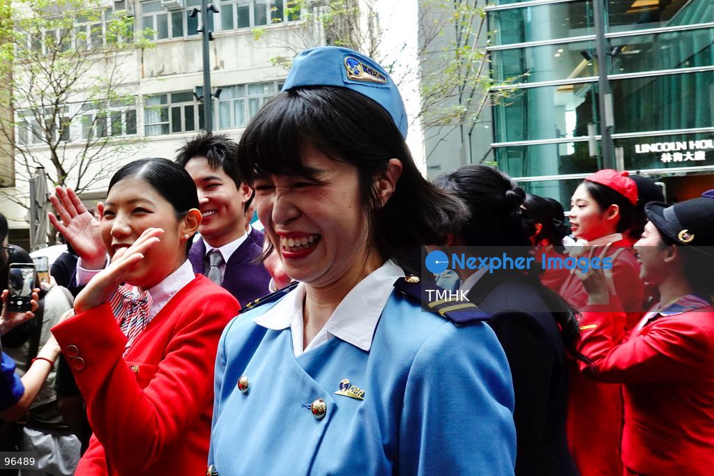 A general view shows cabin crew and ground staff wearing vintage and current uniforms performing alongside professional dancers during Cathay Pacific's 80th anniversary dance performance at Taikoo Place in Quarry Bay on September 24, 2026 in Hong Kong. Choreographed by the Hong Kong Dance Company, the flash mob-style showcase celebrated the airline's eight decades of journey alongside the city. (Photo by Zulu Lo/TMHK via Nexpher Images)