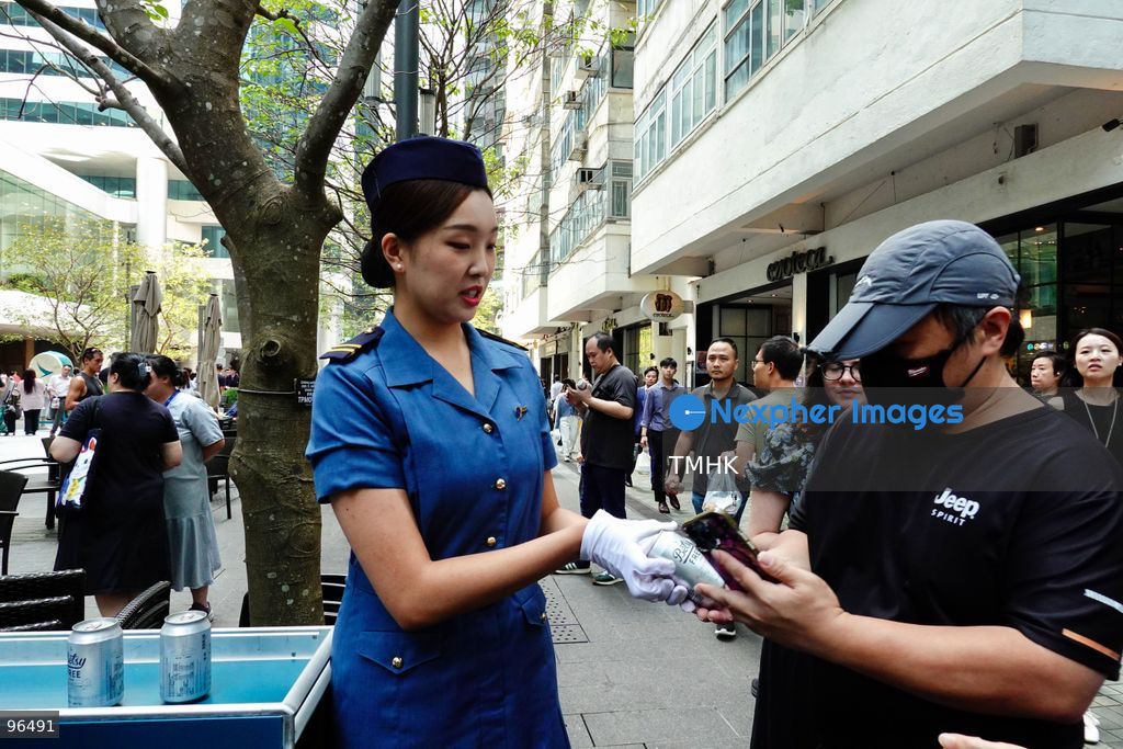 A close-up view shows a Cathay Pacific staff member handing a can of "Betsy Beer" to a spectator during the airline's 80th anniversary showcase on September 24, 2026 in Hong Kong. (Photo by Zulu Lo/TMHK via Nexpher Images)