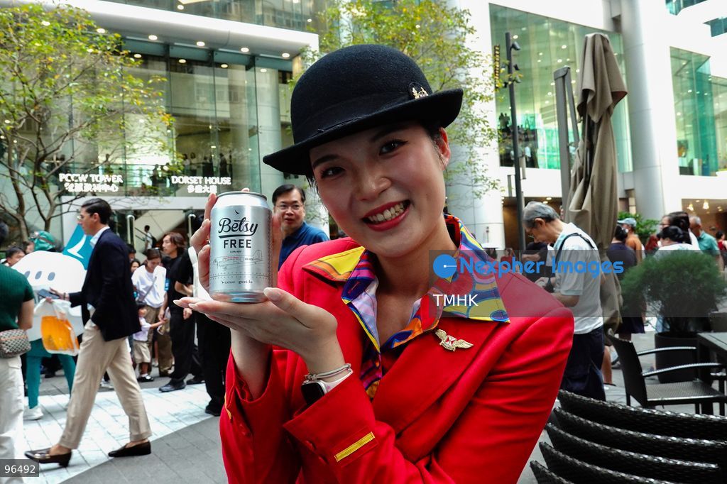 Cathay Pacific staff members and cabin crew distribute cans of the airline's signature "Betsy Beer" to members of the public during the carrier's 80th anniversary celebration at Taikoo Place on September 24, 2026 in Hong Kong. (Photo by Zulu Lo/TMHK via Nexpher Images)
