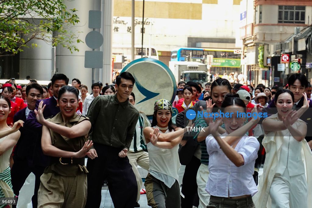 A general view shows cabin crew and ground staff wearing vintage and current uniforms performing alongside professional dancers during Cathay Pacific's 80th anniversary dance performance at Taikoo Place in Quarry Bay on September 24, 2026 in Hong Kong. Choreographed by the Hong Kong Dance Company, the flash mob-style showcase celebrated the airline's eight decades of journey alongside the city. (Photo by Zulu Lo/TMHK via Nexpher Images)