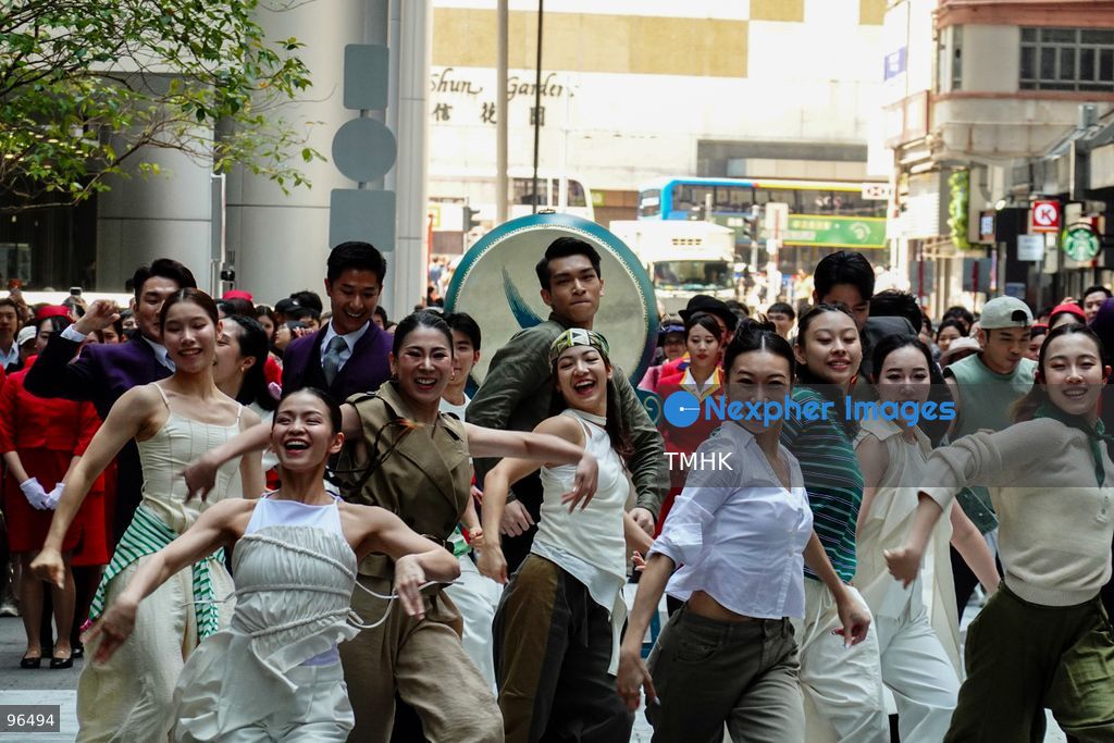A general view shows cabin crew and ground staff wearing vintage and current uniforms performing alongside professional dancers during Cathay Pacific's 80th anniversary dance performance at Taikoo Place in Quarry Bay on September 24, 2026 in Hong Kong. Choreographed by the Hong Kong Dance Company, the flash mob-style showcase celebrated the airline's eight decades of journey alongside the city. (Photo by Zulu Lo/TMHK via Nexpher Images)