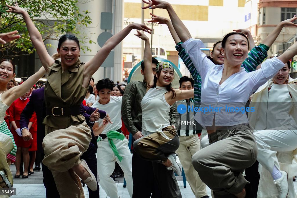 A general view shows cabin crew and ground staff wearing vintage and current uniforms performing alongside professional dancers during Cathay Pacific's 80th anniversary dance performance at Taikoo Place in Quarry Bay on September 24, 2026 in Hong Kong. Choreographed by the Hong Kong Dance Company, the flash mob-style showcase celebrated the airline's eight decades of journey alongside the city. (Photo by Zulu Lo/TMHK via Nexpher Images)