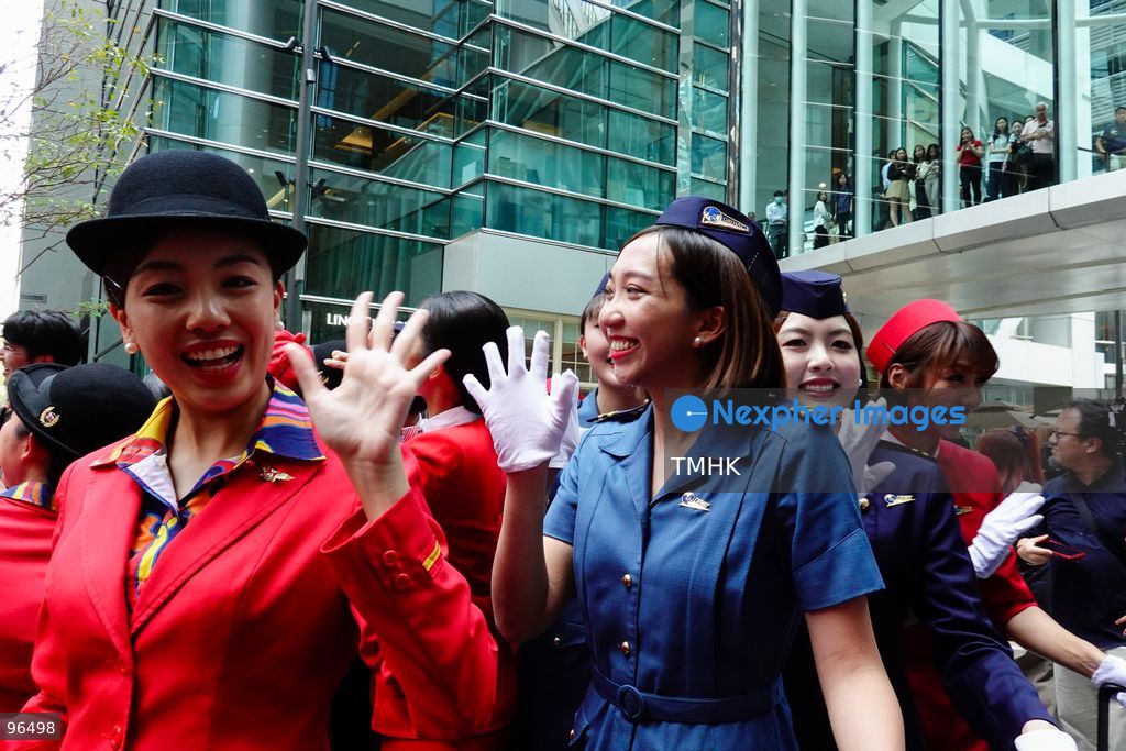 A general view shows cabin crew and ground staff wearing vintage and current uniforms performing alongside professional dancers during Cathay Pacific's 80th anniversary dance performance at Taikoo Place in Quarry Bay on September 24, 2026 in Hong Kong. Choreographed by the Hong Kong Dance Company, the flash mob-style showcase celebrated the airline's eight decades of journey alongside the city. (Photo by Zulu Lo/TMHK via Nexpher Images)
