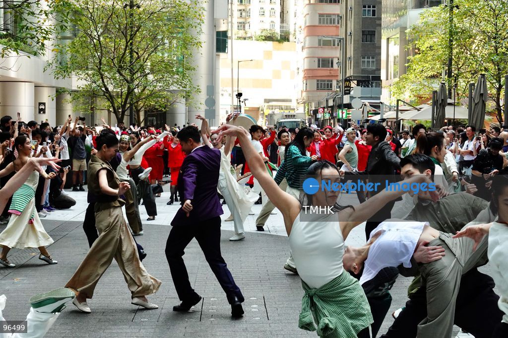 A general view shows cabin crew and ground staff wearing vintage and current uniforms performing alongside professional dancers during Cathay Pacific's 80th anniversary dance performance at Taikoo Place in Quarry Bay on September 24, 2026 in Hong Kong. Choreographed by the Hong Kong Dance Company, the flash mob-style showcase celebrated the airline's eight decades of journey alongside the city. (Photo by Zulu Lo/TMHK via Nexpher Images)