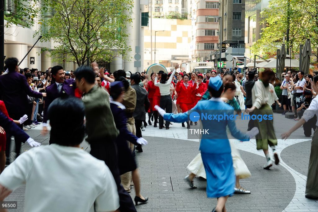 A general view shows cabin crew and ground staff wearing vintage and current uniforms performing alongside professional dancers during Cathay Pacific's 80th anniversary dance performance at Taikoo Place in Quarry Bay on September 24, 2026 in Hong Kong. Choreographed by the Hong Kong Dance Company, the flash mob-style showcase celebrated the airline's eight decades of journey alongside the city. (Photo by Zulu Lo/TMHK via Nexpher Images)