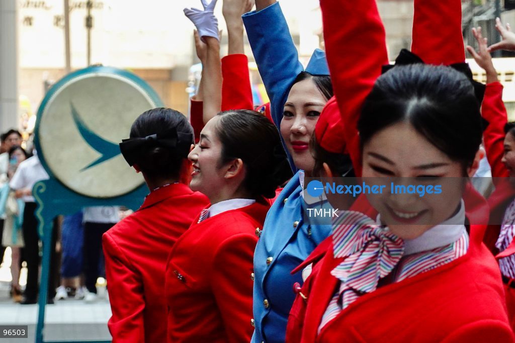 A general view shows cabin crew and ground staff wearing vintage and current uniforms performing alongside professional dancers during Cathay Pacific's 80th anniversary dance performance at Taikoo Place in Quarry Bay on September 24, 2026 in Hong Kong. Choreographed by the Hong Kong Dance Company, the flash mob-style showcase celebrated the airline's eight decades of journey alongside the city. (Photo by Zulu Lo/TMHK via Nexpher Images)