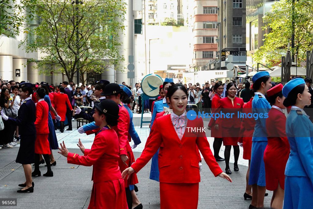 A general view shows cabin crew and ground staff wearing vintage and current uniforms performing alongside professional dancers during Cathay Pacific's 80th anniversary dance performance at Taikoo Place in Quarry Bay on September 24, 2026 in Hong Kong. Choreographed by the Hong Kong Dance Company, the flash mob-style showcase celebrated the airline's eight decades of journey alongside the city. (Photo by Zulu Lo/TMHK via Nexpher Images)