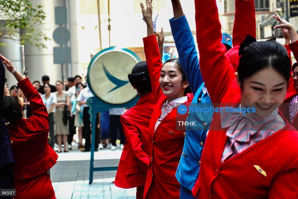 A general view shows cabin crew and ground staff wearing vintage and current uniforms performing alongside professional dancers during Cathay Pacific's 80th anniversary dance performance at Taikoo Place in Quarry Bay on September 24, 2026 in Hong Kong. Choreographed by the Hong Kong Dance Company, the flash mob-style showcase celebrated the airline's eight decades of journey alongside the city. (Photo by Zulu Lo/TMHK via Nexpher Images)