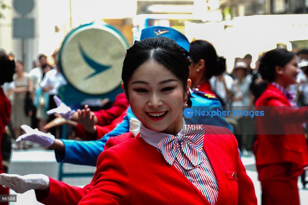 A general view shows cabin crew and ground staff wearing vintage and current uniforms performing alongside professional dancers during Cathay Pacific's 80th anniversary dance performance at Taikoo Place in Quarry Bay on September 24, 2026 in Hong Kong. Choreographed by the Hong Kong Dance Company, the flash mob-style showcase celebrated the airline's eight decades of journey alongside the city. (Photo by Zulu Lo/TMHK via Nexpher Images)