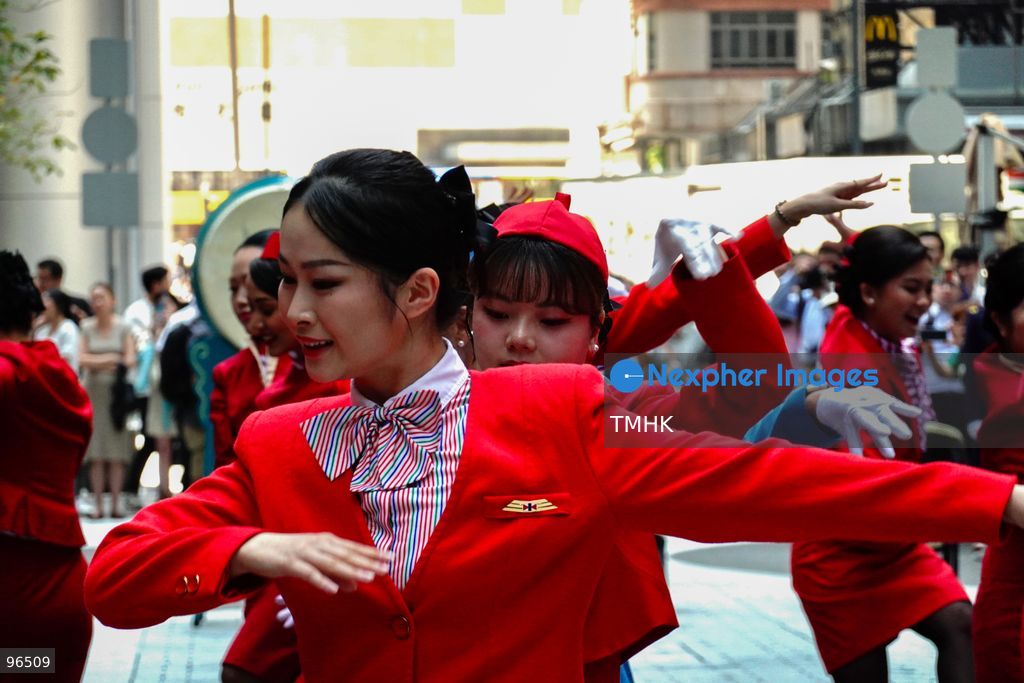 A general view shows cabin crew and ground staff wearing vintage and current uniforms performing alongside professional dancers during Cathay Pacific's 80th anniversary dance performance at Taikoo Place in Quarry Bay on September 24, 2026 in Hong Kong. Choreographed by the Hong Kong Dance Company, the flash mob-style showcase celebrated the airline's eight decades of journey alongside the city. (Photo by Zulu Lo/TMHK via Nexpher Images)