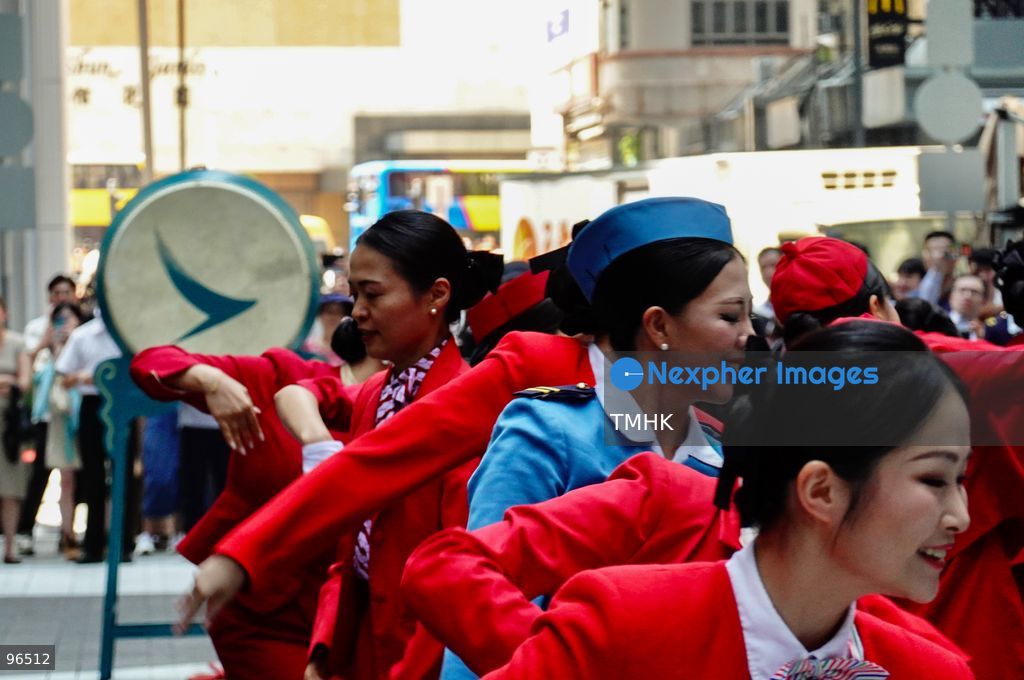 A general view shows cabin crew and ground staff wearing vintage and current uniforms performing alongside professional dancers during Cathay Pacific's 80th anniversary dance performance at Taikoo Place in Quarry Bay on September 24, 2026 in Hong Kong. Choreographed by the Hong Kong Dance Company, the flash mob-style showcase celebrated the airline's eight decades of journey alongside the city. (Photo by Zulu Lo/TMHK via Nexpher Images)