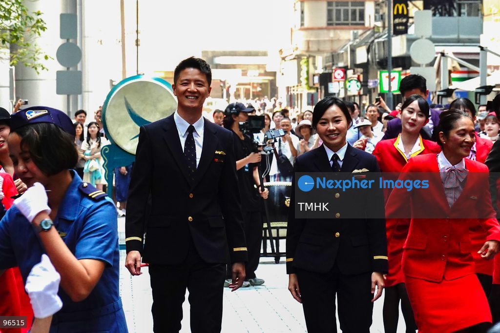 A general view shows cabin crew and ground staff wearing vintage and current uniforms performing alongside professional dancers during Cathay Pacific's 80th anniversary dance performance at Taikoo Place in Quarry Bay on September 24, 2026 in Hong Kong. Choreographed by the Hong Kong Dance Company, the flash mob-style showcase celebrated the airline's eight decades of journey alongside the city. (Photo by Zulu Lo/TMHK via Nexpher Images)