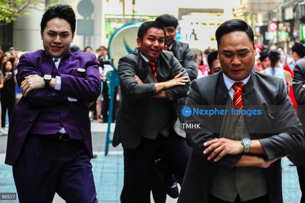 A general view shows cabin crew and ground staff wearing vintage and current uniforms performing alongside professional dancers during Cathay Pacific's 80th anniversary dance performance at Taikoo Place in Quarry Bay on September 24, 2026 in Hong Kong. Choreographed by the Hong Kong Dance Company, the flash mob-style showcase celebrated the airline's eight decades of journey alongside the city. (Photo by Zulu Lo/TMHK via Nexpher Images)