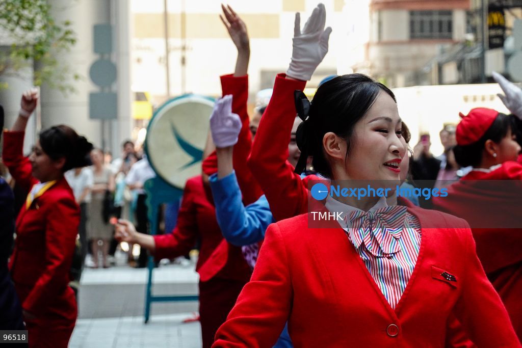 A general view shows cabin crew and ground staff wearing vintage and current uniforms performing alongside professional dancers during Cathay Pacific's 80th anniversary dance performance at Taikoo Place in Quarry Bay on September 24, 2026 in Hong Kong. Choreographed by the Hong Kong Dance Company, the flash mob-style showcase celebrated the airline's eight decades of journey alongside the city. (Photo by Zulu Lo/TMHK via Nexpher Images)