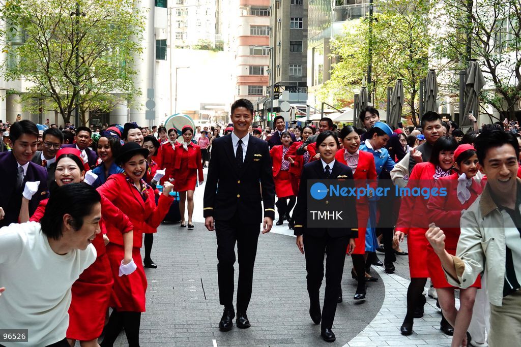 A general view shows cabin crew and ground staff wearing vintage and current uniforms performing alongside professional dancers during Cathay Pacific's 80th anniversary dance performance at Taikoo Place in Quarry Bay on September 24, 2026 in Hong Kong. Choreographed by the Hong Kong Dance Company, the flash mob-style showcase celebrated the airline's eight decades of journey alongside the city. (Photo by Zulu Lo/TMHK via Nexpher Images)