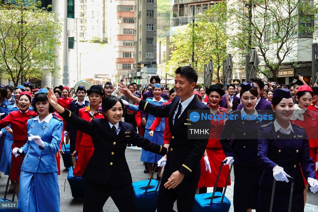 A general view shows cabin crew and ground staff wearing vintage and current uniforms performing alongside professional dancers during Cathay Pacific's 80th anniversary dance performance at Taikoo Place in Quarry Bay on September 24, 2026 in Hong Kong. Choreographed by the Hong Kong Dance Company, the flash mob-style showcase celebrated the airline's eight decades of journey alongside the city. (Photo by Zulu Lo/TMHK via Nexpher Images)