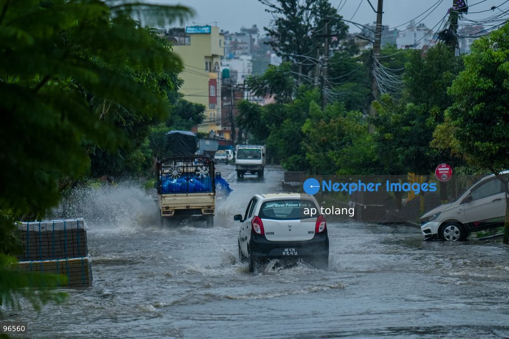 KATHMANDU, NEPAL —September 25, 2026: Heavy rainfall has caused water to overflow onto roads, disrupting the daily lives of residents and hindering vehicle movement in the Khumaltar area of Lalitpur, Nepal. The rainfall has disrupted daily activities as a deep depression over the Bay of Bengal continues to influence weather conditions in the region. (Photo by ap tolang/Nexpher Images)